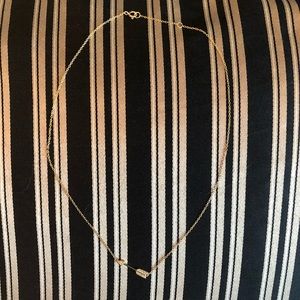 Gold arrow necklace.